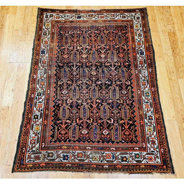 Discover the exquisite artistry and authentic craftsmanship of this magnificent Early 20th Century Vintage Persian Malayer...