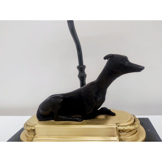 The Chelsea House Whippet (or Greyhound) Bookcase Lamp is a vintage mid-century figural lamp featuring a patinated bronze...