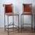 A set of four spanish hacienda wrought iron and leather counter stools, 1960s. 17 inches wide by 23 inches deep by 41...