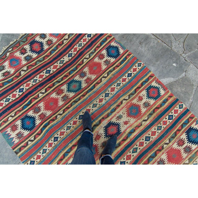 An outstanding finely woven antique Kilim with earthly contrasting color combinations and an overall geometric design....