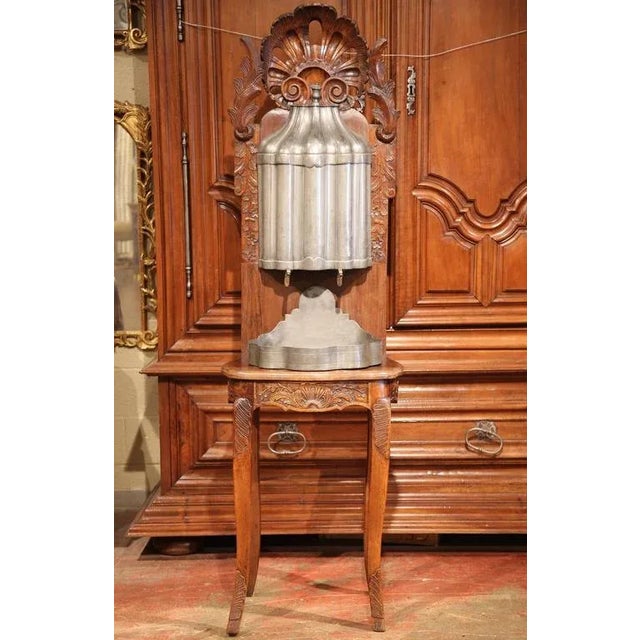 A rare survivor of 18th-century French domestic life, this antique Louis XV lavabo combines sculptural walnut carving with...