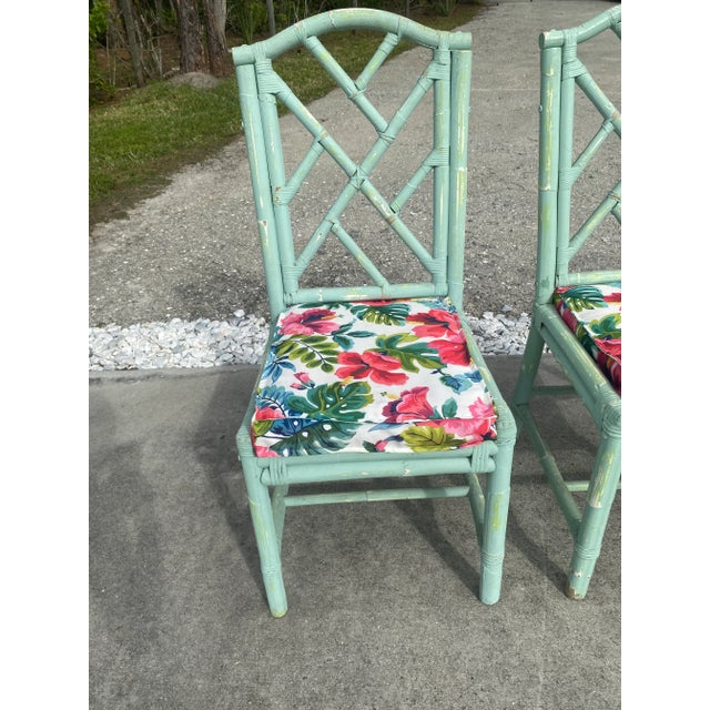 Fantastic Coastal Boho Distressed Aqua Rattan Chippendale Dining Chairs. These chairs are painted aqua and have a...