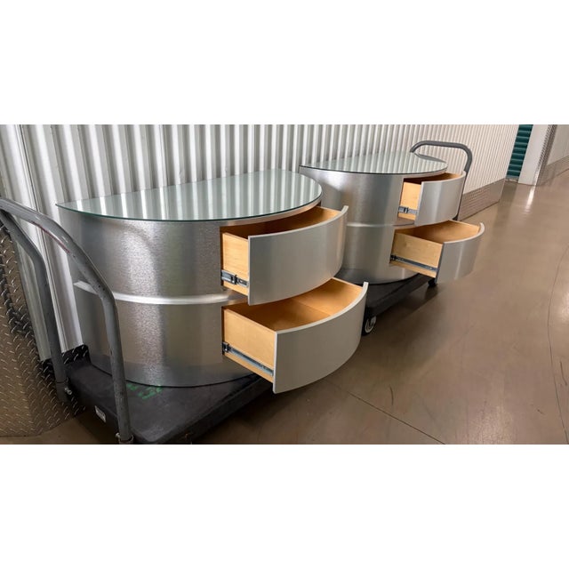 These are a pair vintage oversized nightstands from the 1970s. They are brushed aluminum over solid wood. They have two...