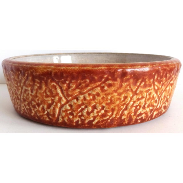 A vintage French faience earthenware round baking dish -- for casseroles, small tarts or cakes. Textured brown on the...