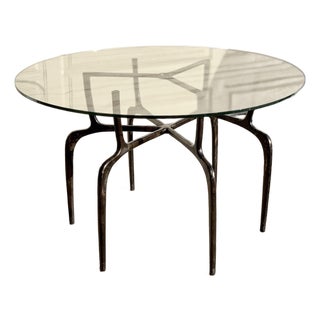 Sculptural Antique Bronzed Iron Legs Round 48” Glass Top Cyrano Dining Table by Made Goods For Sale
