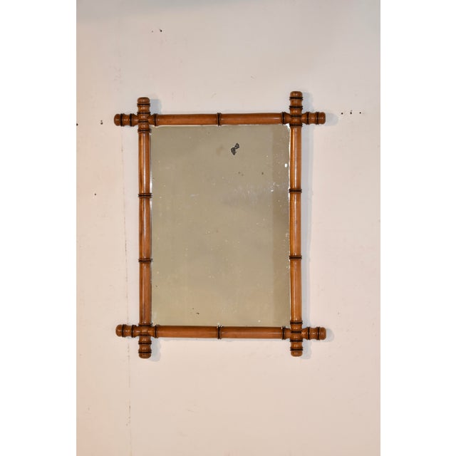 Circa 1900 faux bamboo mirror from France made from cherry. The frame is stunning on this hand turned cherry mirror. It...