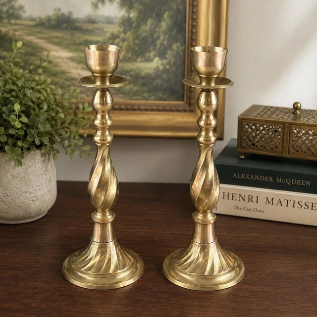 Elevate your décor with this elegant pair of vintage 13-inch solid brass candlesticks. Featuring beautifully twisted...