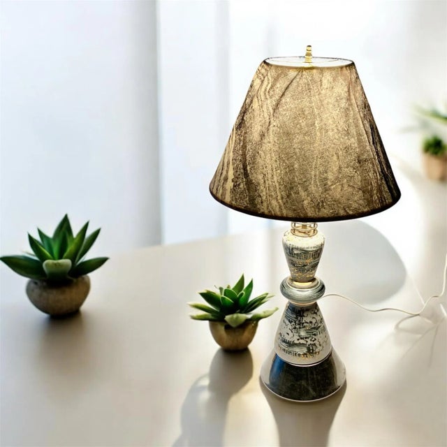 Atomic Mid-Century Ceramic Lamp with Black, Gray and Gold Design with Complementary Gray Swirled Fabric Shade Base has a...