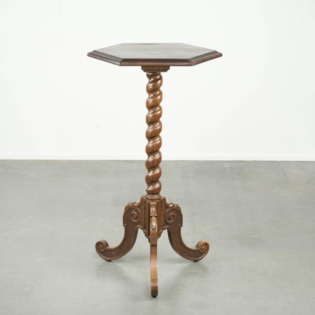 This graceful antique tall oak plant/side table features beautiful, warm colors and is richly finished with fine wood...