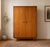 A stylish 1960s Butilux wardrobe in beautifully figured teak veneer, featuring recessed circular handles and tapered legs....
