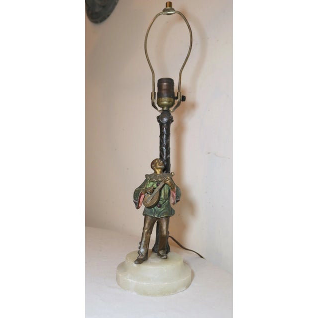 Up for sale is a very nice quality antique figural clown electric table lamp made in Austria. The clown leans on a palm...