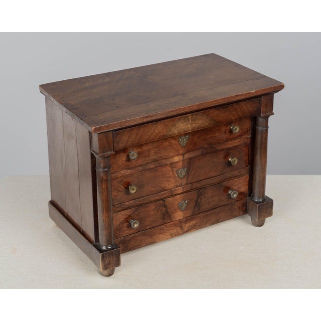 A fine early 19th century French Empire miniature sample commode crafted of solid and veneer of walnut with deep, striking...