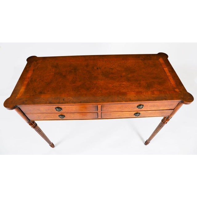 This is an elegant English burr walnut console table dating from the 1950's. This magnificent piece is crafted from...