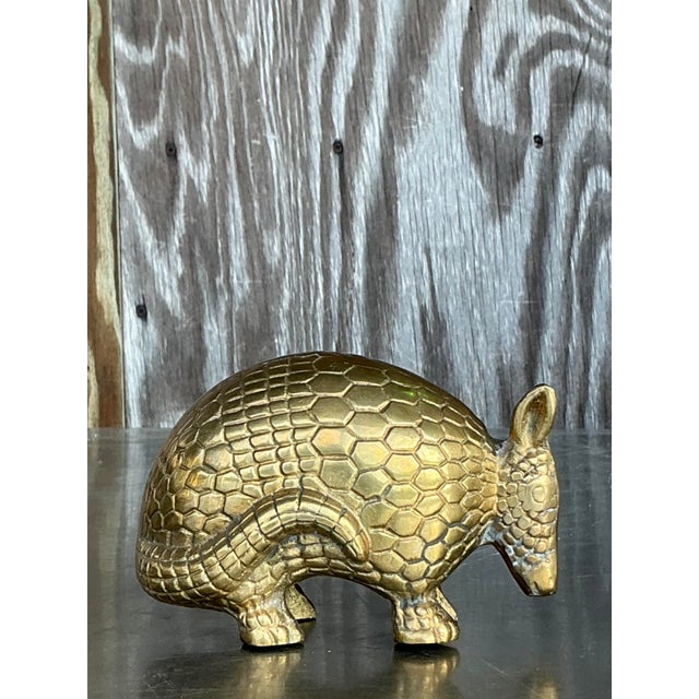 This charming vintage brass armadillo sculpture is a delightful addition to any eclectic or bohemian-inspired space....