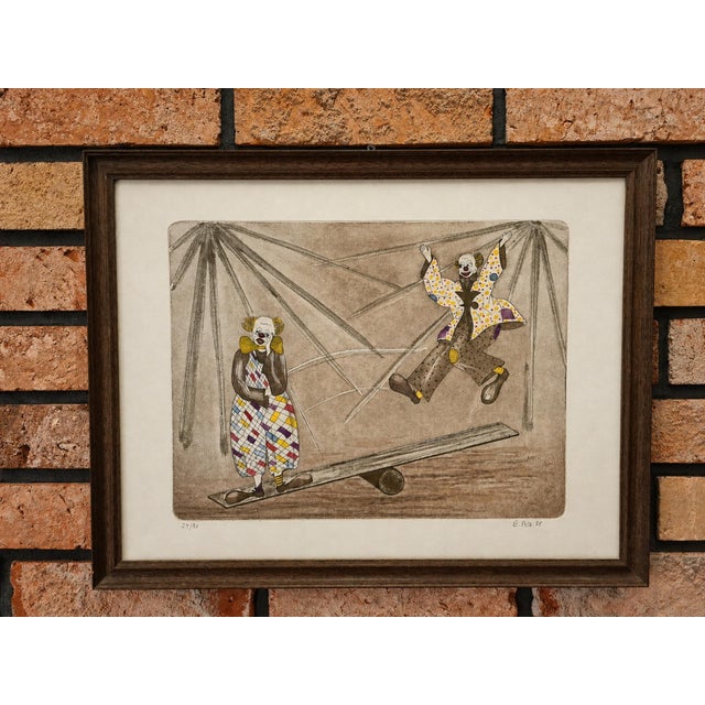 A charming, original print from 1988 depicting an expressive and nostalgic circus scene featuring two clowns on a balance...