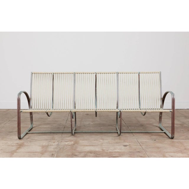 Bronze three seater sofa by Walter Lamb for Brown Jordan. The sofa has a beautiful curved construction in tubular bronze...