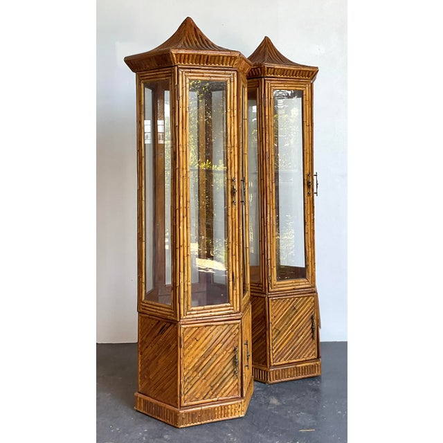 This striking pair of vintage tall cabinets captures the essence of Hollywood Regency glamour with a distinct Chinoiserie...