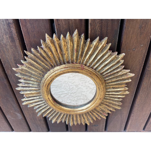 The Vintage small scale Italian wooden Sunburst Mirror is a stylish and elegant addition to any home. This design draws...
