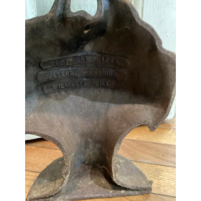 Waverly Studios copyright 1925 bouquet doorstop. Manufactured in Wilmette, Illinois and made of cast iron. Heavy and sturdy.