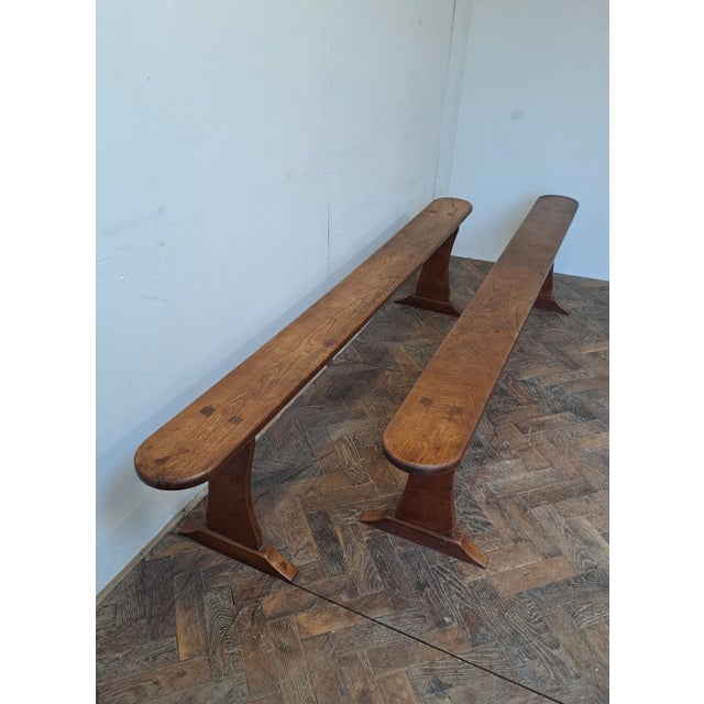 A charming pair of 19th-century French cherrywood benches, originally made to accompany a farm or refectory table, full of...