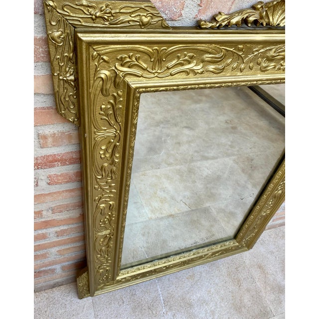 Spanish Colonial style handcrafted mirror. Rectangular hand carved wooden structure with gold foiled finish, Spain, 1960....