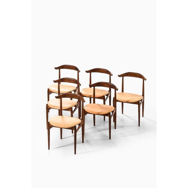 This very rare set of six “cowhorn” dining chairs, model 215, was designed by knud færch and produced by slagelse...