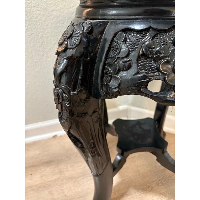 Beautiful mid-20th-century Asian export plant stand (or low accent side table) featuring stunning, detailed hand-carved...