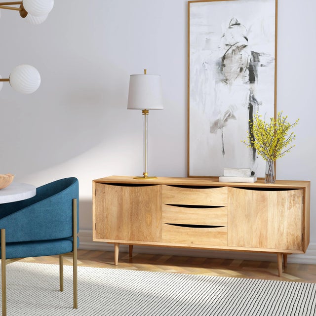 Curved lines paired with a clean silhouette make up this 67" mid-century style tv stand. Featuring a warm natural finish...