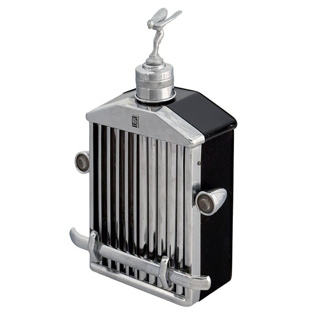 A fine vintage Rolls-Royce radiator grille-shaped novelty whiskey decanter or flask with a working music box from the...