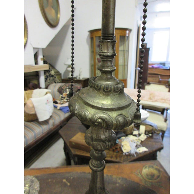 Pair of table lamps made from Baroque style altar candlesticks in silvered metal, with repousse scrollwork, turned...