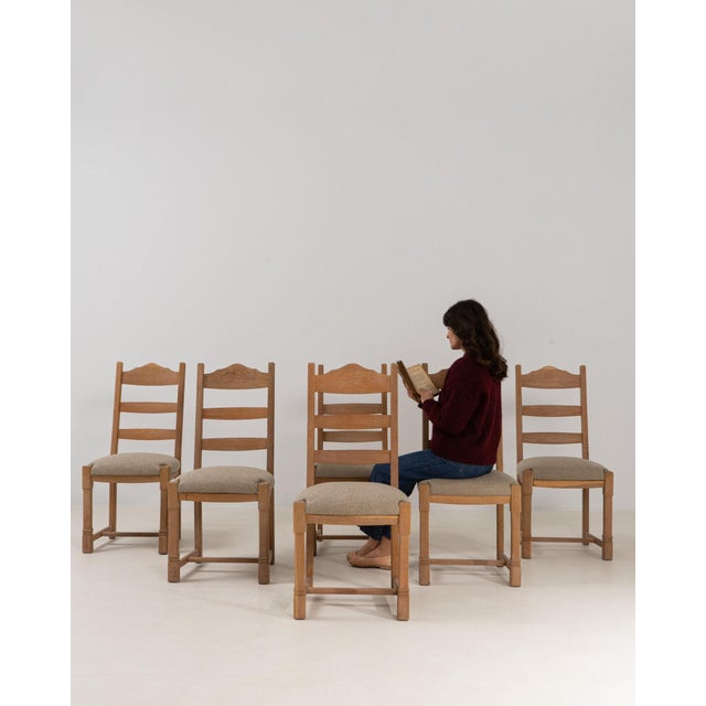 This dining chair makes its impression through natural bleached oak, shaped crest rail. Dating to 1970s and originating...