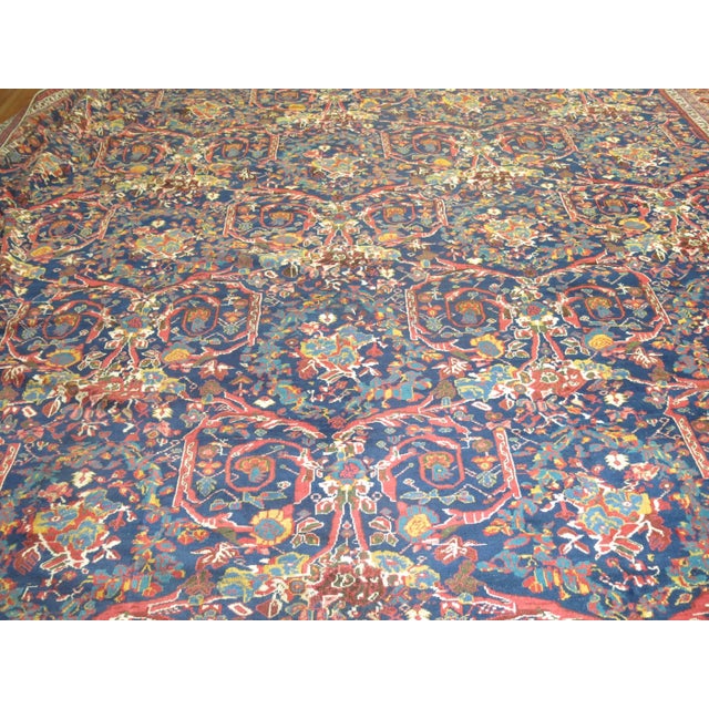 Rare oversize square Persian Mahal rug with all-over mustafi design on a navy field background, circa 1910, measures:...