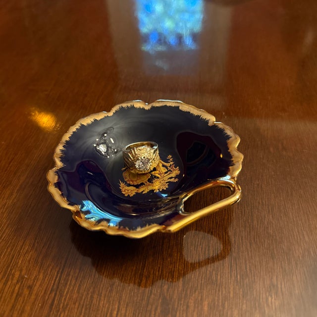 Lovely vintage French Limoges cobalt blue glazed leaf form cupped dish with handle, gold gilt accents and a central design...