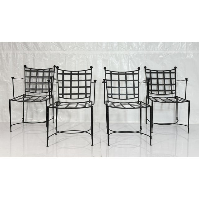 A striking set of four wrought iron dining armchairs originally designed by Mario Papperzini and produced in Italy for...