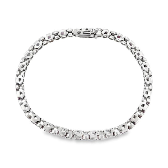 Vintage 14K white gold tennis bracelet featuring a sequence of alternating princess-cut pink sapphires and brilliant-cut...