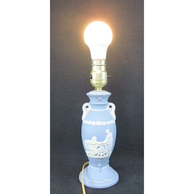 This is a wonderful and unique piece of history and ceramic art! This vintage table lamp is prominently marked "Occupied...