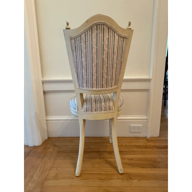 Upholstered Louis XVI accent chair clad in feminine pink, blue, brown and neutral stripe repeat. This chair boasts...