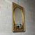 A refined and dramatic rectangular wall mirror with a central oval mirror in richly carved and gilded solid wood, a fine...