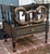 Fancy black lacquered and gilt decorated Canterbury by Bradburn. Elegant accents. This has one drawer for storage and 3...