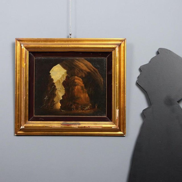 Oil on canvas. Landscape centered on the entrance to a large cave, inside which a couple is being ambushed by a group of...