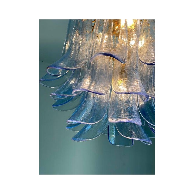 Contemporary and vintage mazzega style chandelier. blue transparent “selle” elements in murano glass, glass elements...