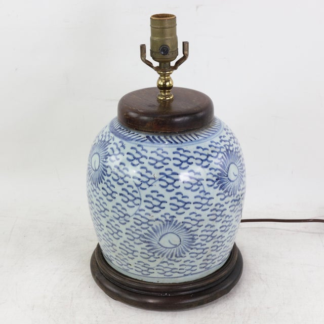 This antique table lamp is repurposed from an authentic white porcelain vase featuring a traditional blue and white...