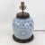 This antique table lamp is repurposed from an authentic white porcelain vase featuring a traditional blue and white...