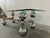 70s coffee table with greenish shimmering glass top and chrome-plated stainless steel frame.