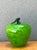 This vibrant vintage art glass apple is a striking example of hand-blown craftsmanship, echoing the celebrated techniques...