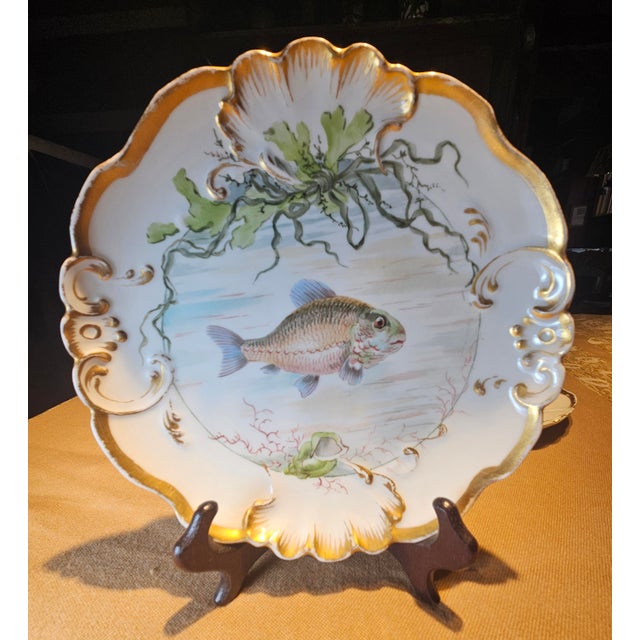 This is a set of three Jean Pouyant Limoges porcelain fish plates. They feature the distinctive JP/L France mark with a...