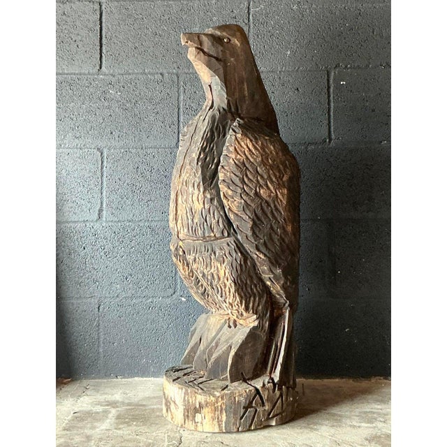 Make a bold statement with this monumental vintage hand-carved eagle sculpture. Hewn from a single solid log, this...