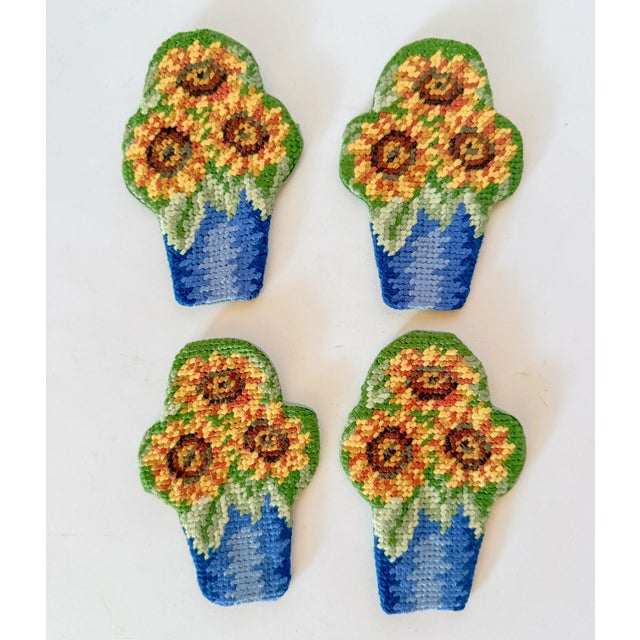 A charming way to set your table! These darling needlepoint pockets feature potted sunflowers and they hold your flatware...