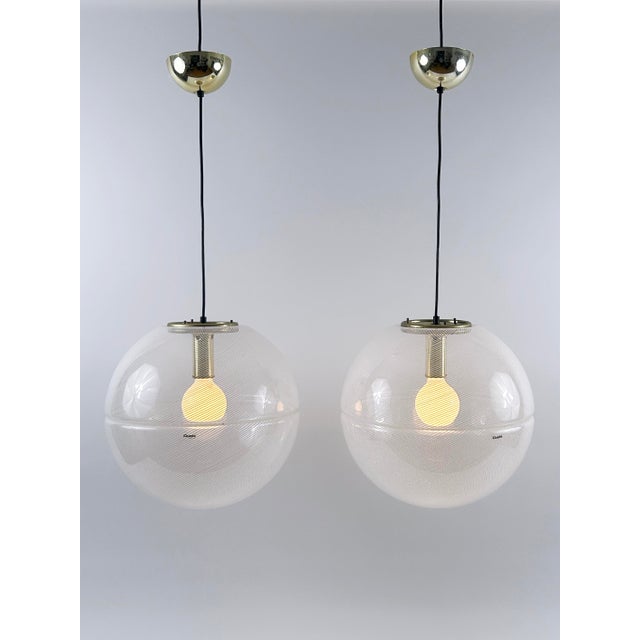 Elegant and highly decorative mid-century modern globe pendant lamps or hanging lights. The shades of the pendant lamps...