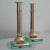 Beautiful pair of Italian Mid-Century Modern brass pedestal candleholders with glass bases in the manner of Fontana Arte....